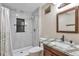 Bathroom featuring gray tile shower, granite countertop and dark wood vanity at 12333 Newport Ct, Brighton, CO 80602