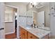 Bathroom featuring a light-colored granite countertop, a large mirror, and a wooden vanity at 12333 Newport Ct, Brighton, CO 80602