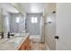 Bathroom features a light-colored granite countertop, wooden vanity, large mirror, and tiled bathtub at 12333 Newport Ct, Brighton, CO 80602