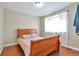 Bedroom with a hardwood floor, a queen-sized bed, and bright natural light from the window at 12333 Newport Ct, Brighton, CO 80602