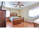Bedroom with hardwood floors, ceiling fan, and two windows providing ample natural light at 12333 Newport Ct, Brighton, CO 80602