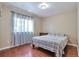 Bedroom with a hardwood floor, a queen-sized bed, and bright natural light from the window at 12333 Newport Ct, Brighton, CO 80602