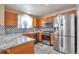 Well-equipped kitchen featuring stainless steel appliances, granite countertops, and ample cabinet space at 12333 Newport Ct, Brighton, CO 80602