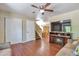 Spacious living room showcasing hardwood floors, a fireplace, and an open layout with access to dining area at 12333 Newport Ct, Brighton, CO 80602