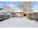 Snowy backyard with detached brick garage and wooden fence at 3737 Jason St, Denver, CO 80211