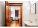 Charming bathroom view through doorway with white sink and vanity, leading to kitchen barstool seating at 3737 Jason St, Denver, CO 80211