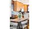 Dining area features a modern table set, with a view to the kitchen and its wooden cabinets at 3737 Jason St, Denver, CO 80211