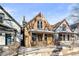Two-story home with a covered front porch and snow-covered yard at 3737 Jason St, Denver, CO 80211