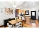 Open-concept kitchen with modern wooden cabinets, dining area, and view to the living room at 3737 Jason St, Denver, CO 80211