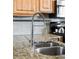 Close-up of stainless steel kitchen sink with granite countertops and spring-neck faucet at 3737 Jason St, Denver, CO 80211