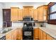 Well-equipped kitchen featuring wooden cabinets, stainless steel appliances, and ample counter space at 3737 Jason St, Denver, CO 80211