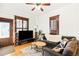 Inviting living room featuring a comfortable gray sofa, wood floors, and abundant natural light at 3737 Jason St, Denver, CO 80211