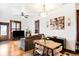 Open-concept living room and dining area with hardwood floors, modern lighting, and stylish decor at 3737 Jason St, Denver, CO 80211