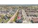 Aerial view of gray townhouse with a view of the surrounding neighborhood with distant lake at 4027 E 98Th Pl, Thornton, CO 80229