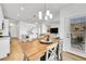 Cozy dining area featuring stylish lighting and seamlessly connecting to the kitchen and living room at 4027 E 98Th Pl, Thornton, CO 80229