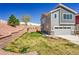 Inviting two-story home featuring a manicured lawn, retaining wall, and attached two-car garage at 4027 E 98Th Pl, Thornton, CO 80229