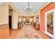 Grand foyer with decorative chandelier, stone tile flooring, and entryway into living room at 4027 E 98Th Pl, Thornton, CO 80229