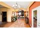 Grand foyer with decorative chandelier, stone tile flooring, and entryway into living room at 4027 E 98Th Pl, Thornton, CO 80229