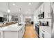 Bright, open-concept kitchen with an island, modern appliances, and sleek countertops at 4027 E 98Th Pl, Thornton, CO 80229