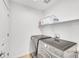 Modern laundry room featuring a washer and dryer set, as well as extra storage space at 4027 E 98Th Pl, Thornton, CO 80229