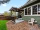 Backyard patio features a pergola, gravel beds, and a chair at 5377 Cloverbrook Cir, Highlands Ranch, CO 80130