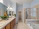 A spacious bathroom featuring double sinks, tiled countertop, walk-in shower and soaking tub at 5377 Cloverbrook Cir, Highlands Ranch, CO 80130