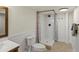 Bathroom featuring tile flooring, shower, and toilet with classic wainscoting at 5377 Cloverbrook Cir, Highlands Ranch, CO 80130