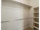 Empty walk-in closet featuring built-in shelving and two metal hanging rods at 5377 Cloverbrook Cir, Highlands Ranch, CO 80130