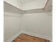Walk-in closet with light wood flooring and simple shelving at 5377 Cloverbrook Cir, Highlands Ranch, CO 80130