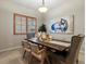 Bright dining area features wood table, neutral decor, and window with wooden shutters at 5377 Cloverbrook Cir, Highlands Ranch, CO 80130