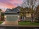 Charming home featuring a two-car garage, manicured lawn, and a cozy front porch at 5377 Cloverbrook Cir, Highlands Ranch, CO 80130