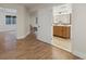 Open hallway with wood floors leading to a stylish bathroom at 5377 Cloverbrook Cir, Highlands Ranch, CO 80130