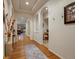 Elegant hallway with hardwood floors, arched doorways, and decorative accents at 5377 Cloverbrook Cir, Highlands Ranch, CO 80130