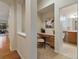 Hallway featuring a cozy office nook and a view of the bathroom at 5377 Cloverbrook Cir, Highlands Ranch, CO 80130