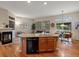 Stylish kitchen featuring a central island, modern appliances, and cozy seating area at 5377 Cloverbrook Cir, Highlands Ranch, CO 80130