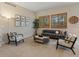 Comfortable living room with neutral tones, stylish furnishings, and natural light from shuttered windows at 5377 Cloverbrook Cir, Highlands Ranch, CO 80130