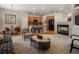 Open concept living space with cozy fireplace, kitchen bar, and dining area at 5377 Cloverbrook Cir, Highlands Ranch, CO 80130