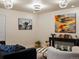 Stylish living room featuring modern artwork and dark furniture at 5377 Cloverbrook Cir, Highlands Ranch, CO 80130