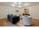 Cozy living room with hardwood floors, modern lighting, and decorative artwork at 5377 Cloverbrook Cir, Highlands Ranch, CO 80130
