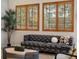 A light filled living room with plantation shuttered windows overlooking a serene yard at 5377 Cloverbrook Cir, Highlands Ranch, CO 80130