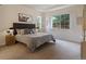 Serene main bedroom featuring soft carpet, tray ceiling and bright windows with shutters at 5377 Cloverbrook Cir, Highlands Ranch, CO 80130