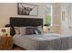Comfortable bedroom with a patterned bedspread, side tables with lamps, and shuttered windows at 5377 Cloverbrook Cir, Highlands Ranch, CO 80130
