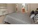 Spacious bedroom with large bed, shelving, and access to the en-suite bathroom at 5377 Cloverbrook Cir, Highlands Ranch, CO 80130
