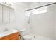 Bathroom with a white tiled shower at 3855 S Monaco St # 166, Denver, CO 80237