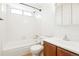 White bathroom features a shower-tub combo and vanity at 3855 S Monaco St # 166, Denver, CO 80237
