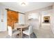 A cozy dining area features a wood barn door, open kitchen, and neutral decor at 3855 S Monaco St # 166, Denver, CO 80237