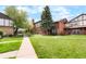 Well-maintained property with landscaped front lawn and sidewalk at 3855 S Monaco St # 166, Denver, CO 80237