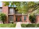 Charming townhome with a red brick exterior and a well-maintained front lawn at 3855 S Monaco St # 166, Denver, CO 80237