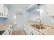 Kitchen featuring stainless steel sink, granite countertops, and light wood floors at 3855 S Monaco St # 166, Denver, CO 80237