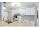 Bright kitchen featuring white cabinets, granite countertops, and stainless steel appliances at 3855 S Monaco St # 166, Denver, CO 80237